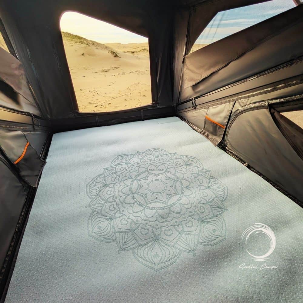 Soulful Mat laid out inside a rooftop tent with a mandala design as mattress topper