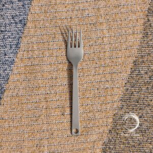 Titanium camping fork on woven outdoor blanket – lightweight, rustproof and eco-friendly Soulful Camper cutlery.