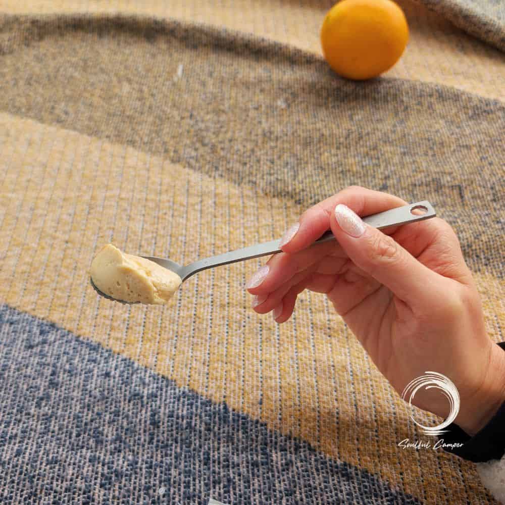 Soulful Camper titanium cutlery spoon scooping food outdoors.